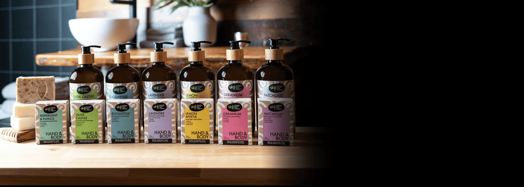 Australian Natural Soap company soap collection bottles and bars on a wooden bench